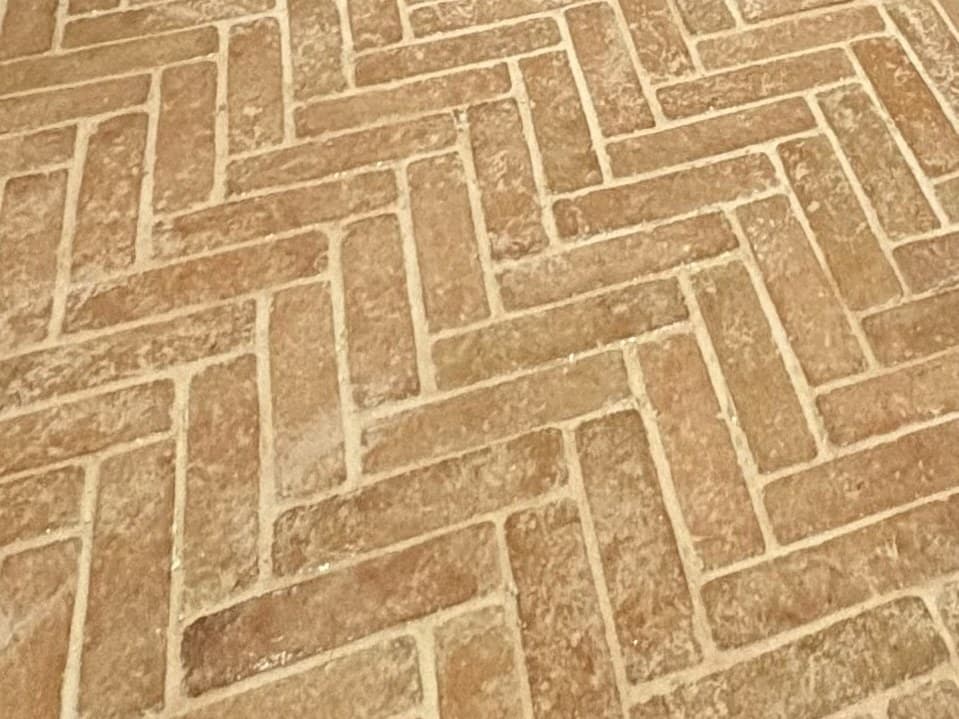 Terracotta herringbone stone flooring